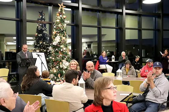 people sitting at tables and clapping