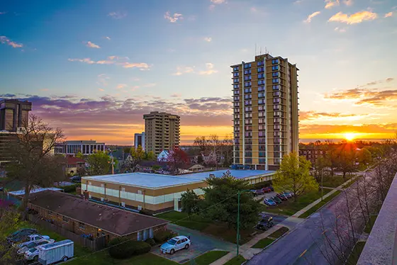 sunset behind tall buildings