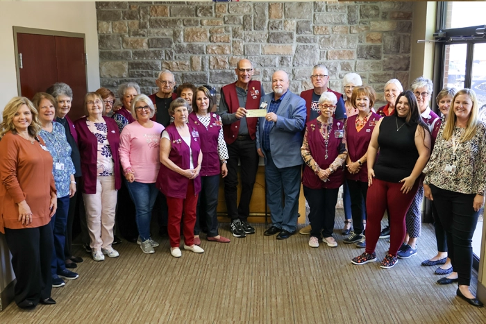 CMH Auxiliary member presenting check