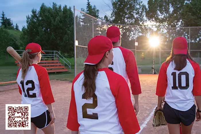 Softball players walking on the field