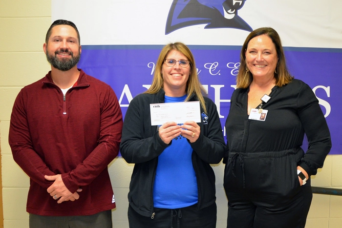 CMH staff presenting check to school staff